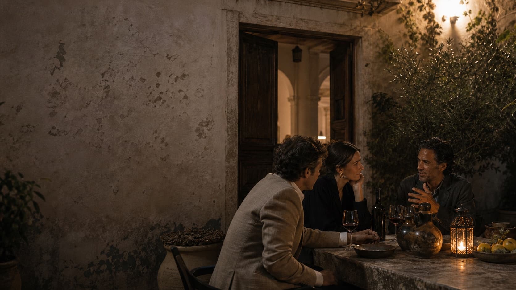 Friends sharing an evening around a courtyard table.